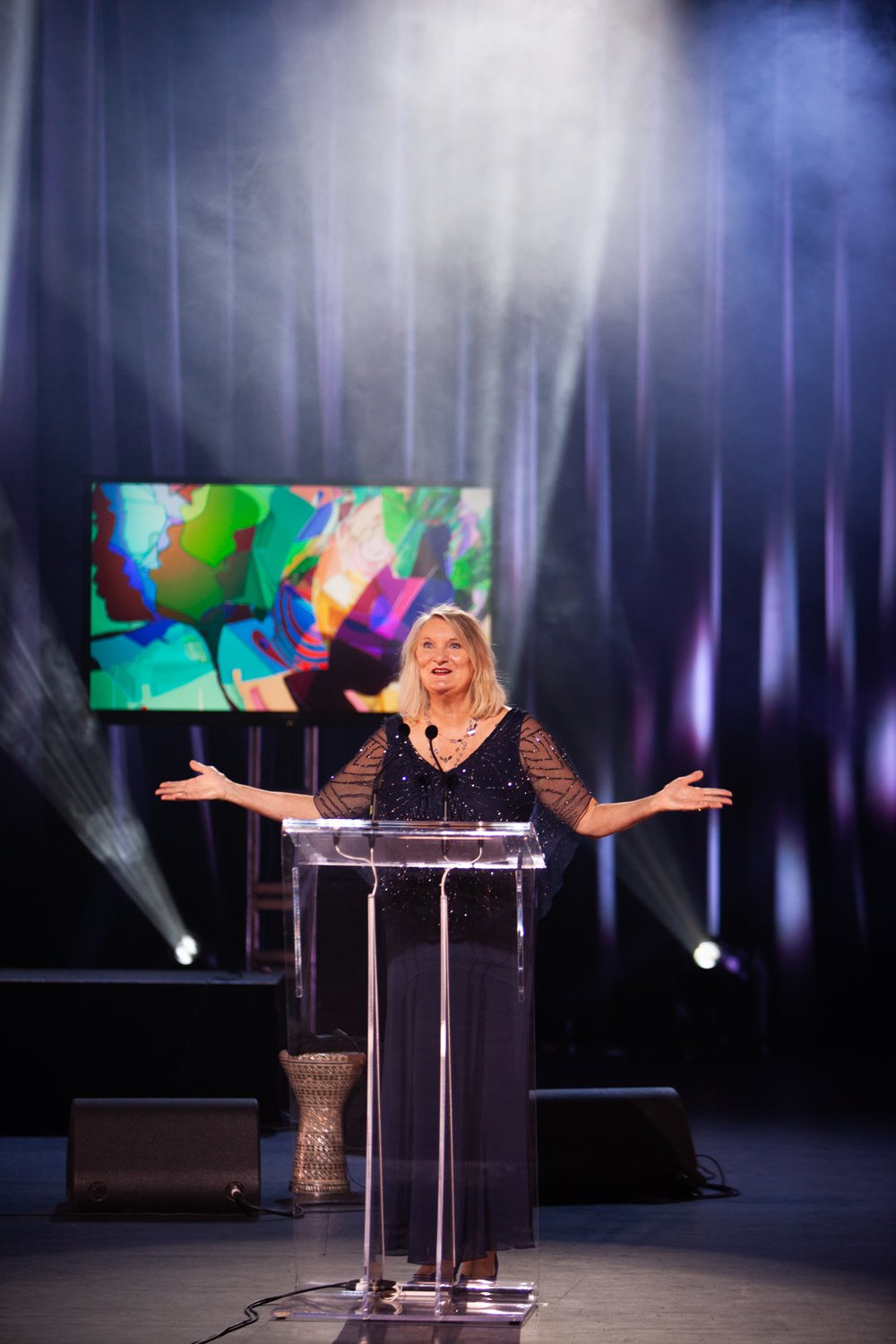 Claire Hopkinson stands at the podium on stage