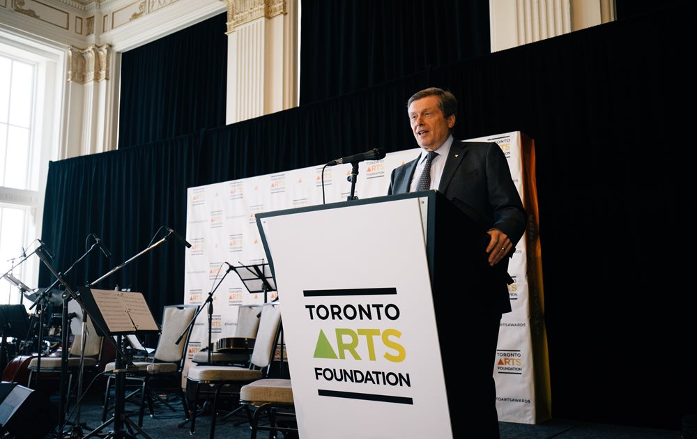 A photo of Mayor Tory at a podium. He is giving a speech.