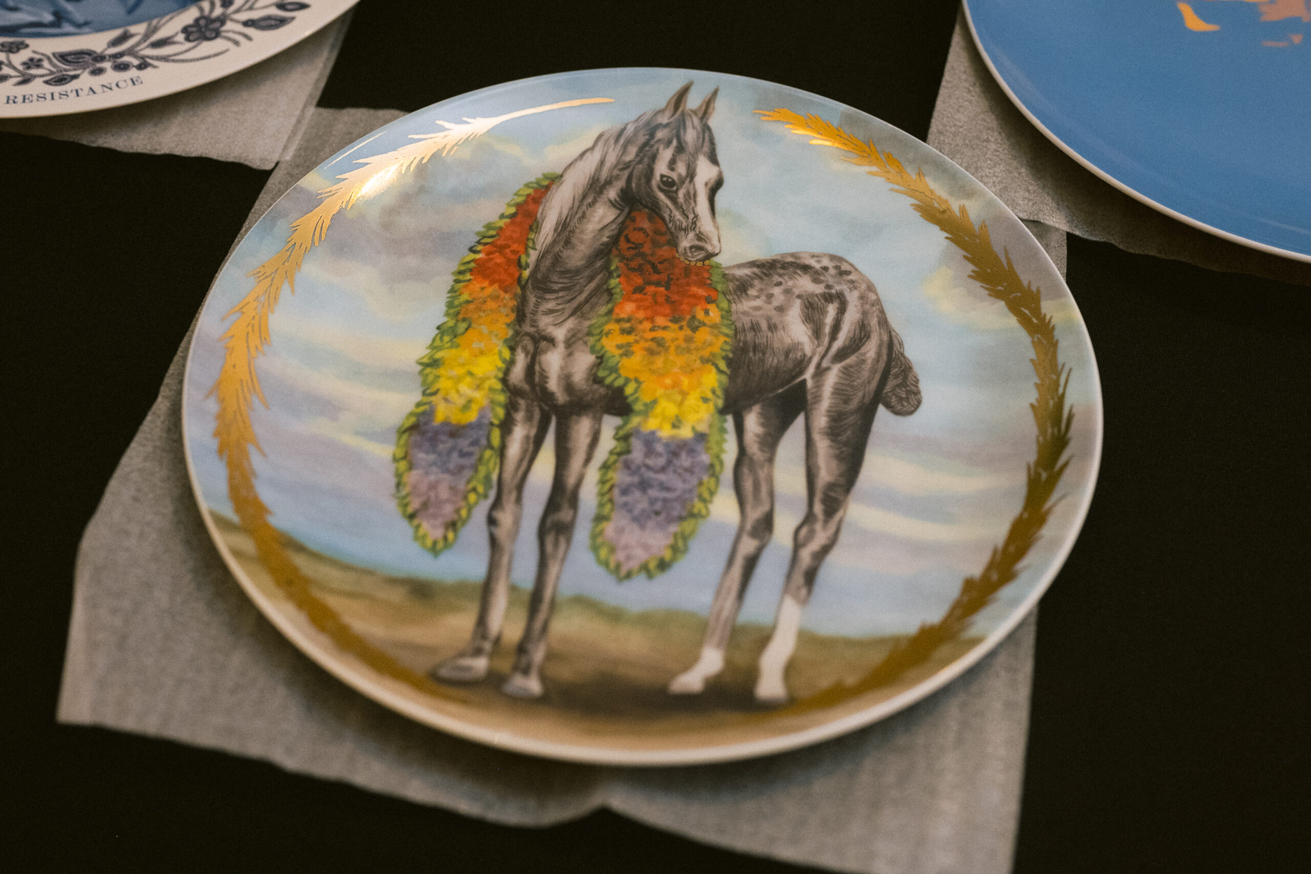 A plate with a horse painted in it.