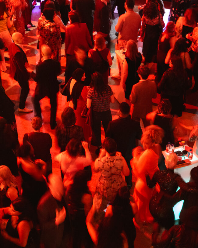 Many people on a dance floor.