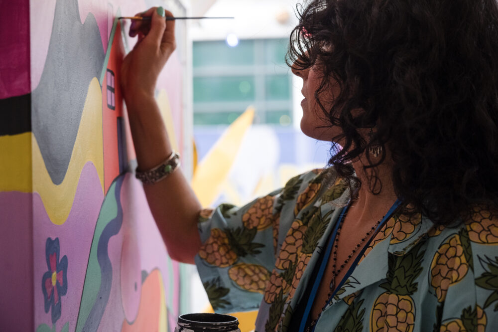 A person paints a mural