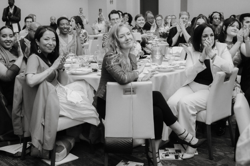 People clap at a round table.