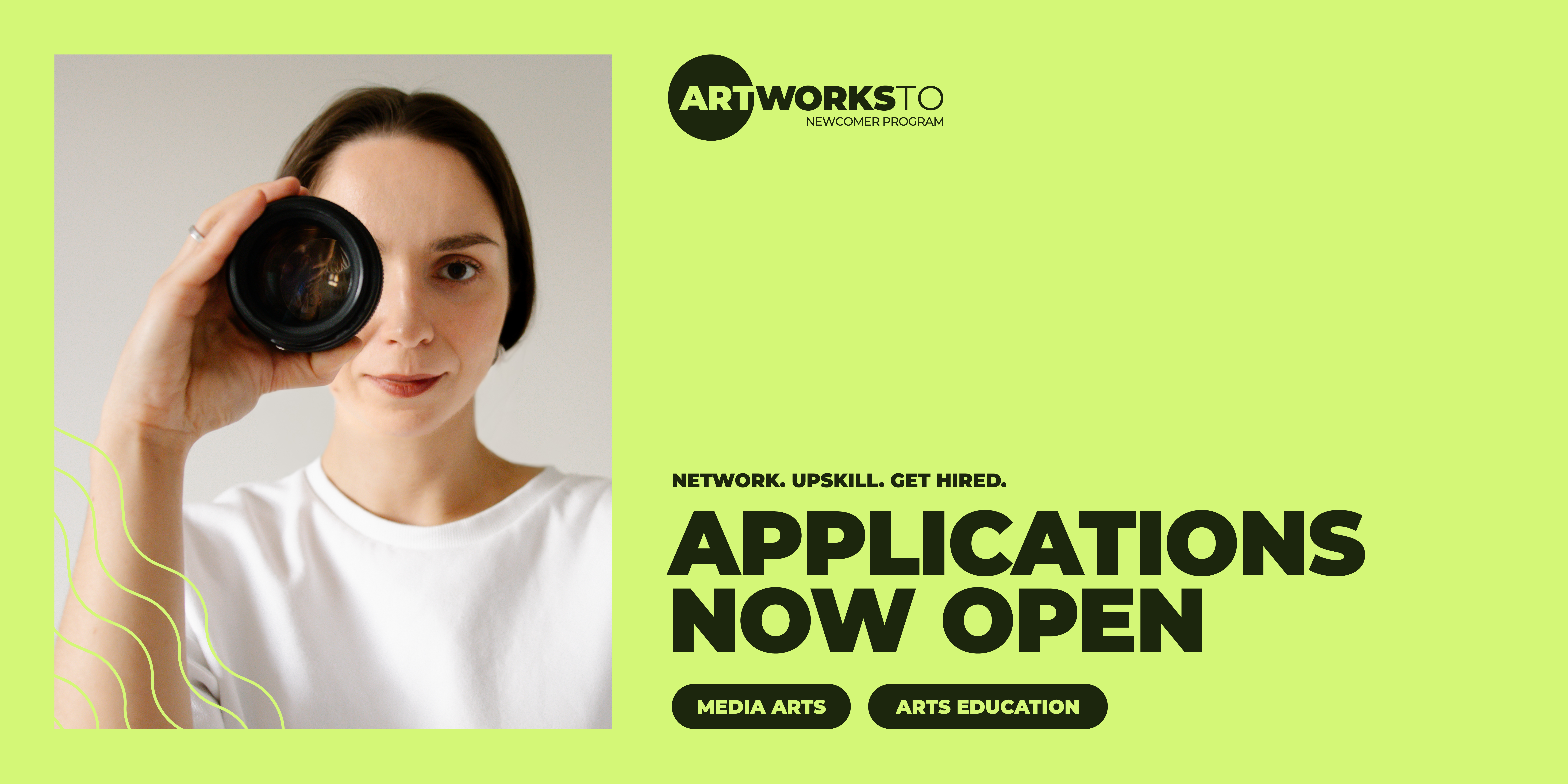 A person looks through a camera lens. Text: Network. Upskill. Get hired. Applications now open.