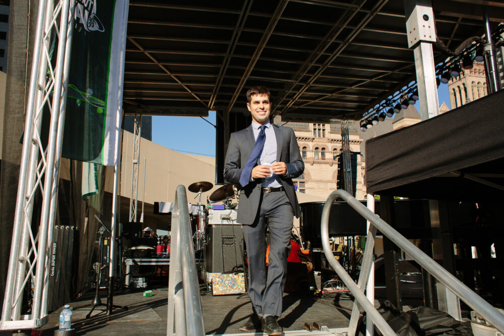 Justin Gray stands on stage.