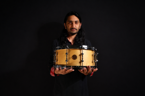 Agneya holds a drum.