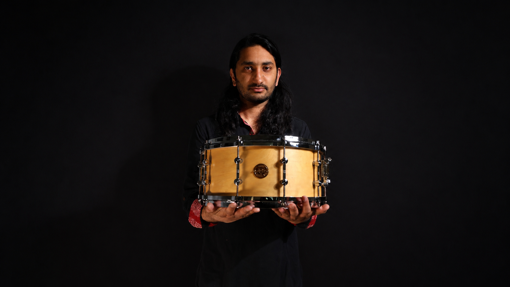 Agneya holds a drum.
