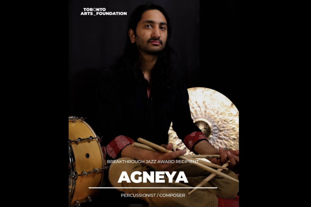 Agneya is pictured holding drumsticks.